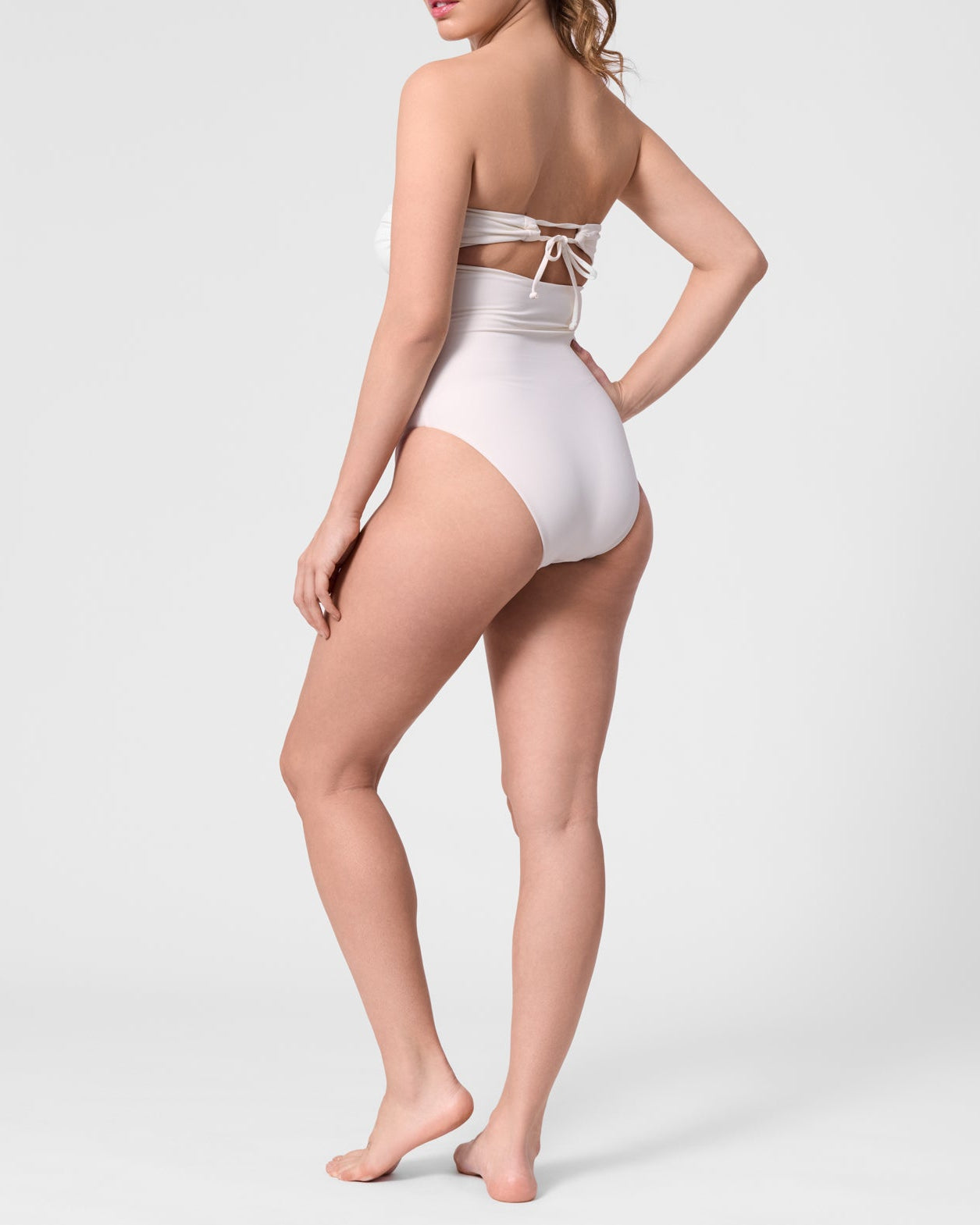 Model wearing the ROEM Bartolome Bandeau Top One Piece in Pearl, back view