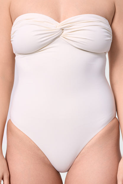Close-up of the twist-front detail on the ROEM Bartolome Bandeau Top One Piece in Pearl