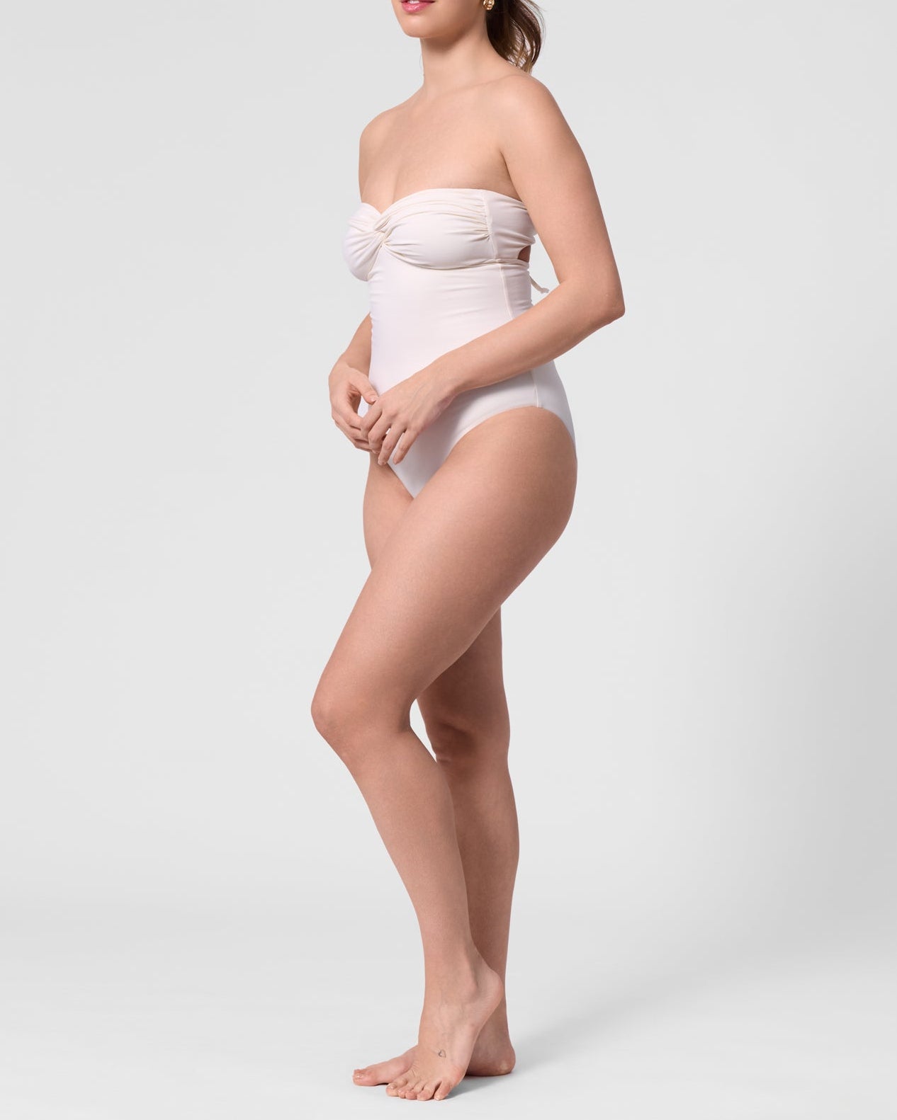 Model wearing the ROEM Bartolome Bandeau Top One Piece in Pearl, side view
