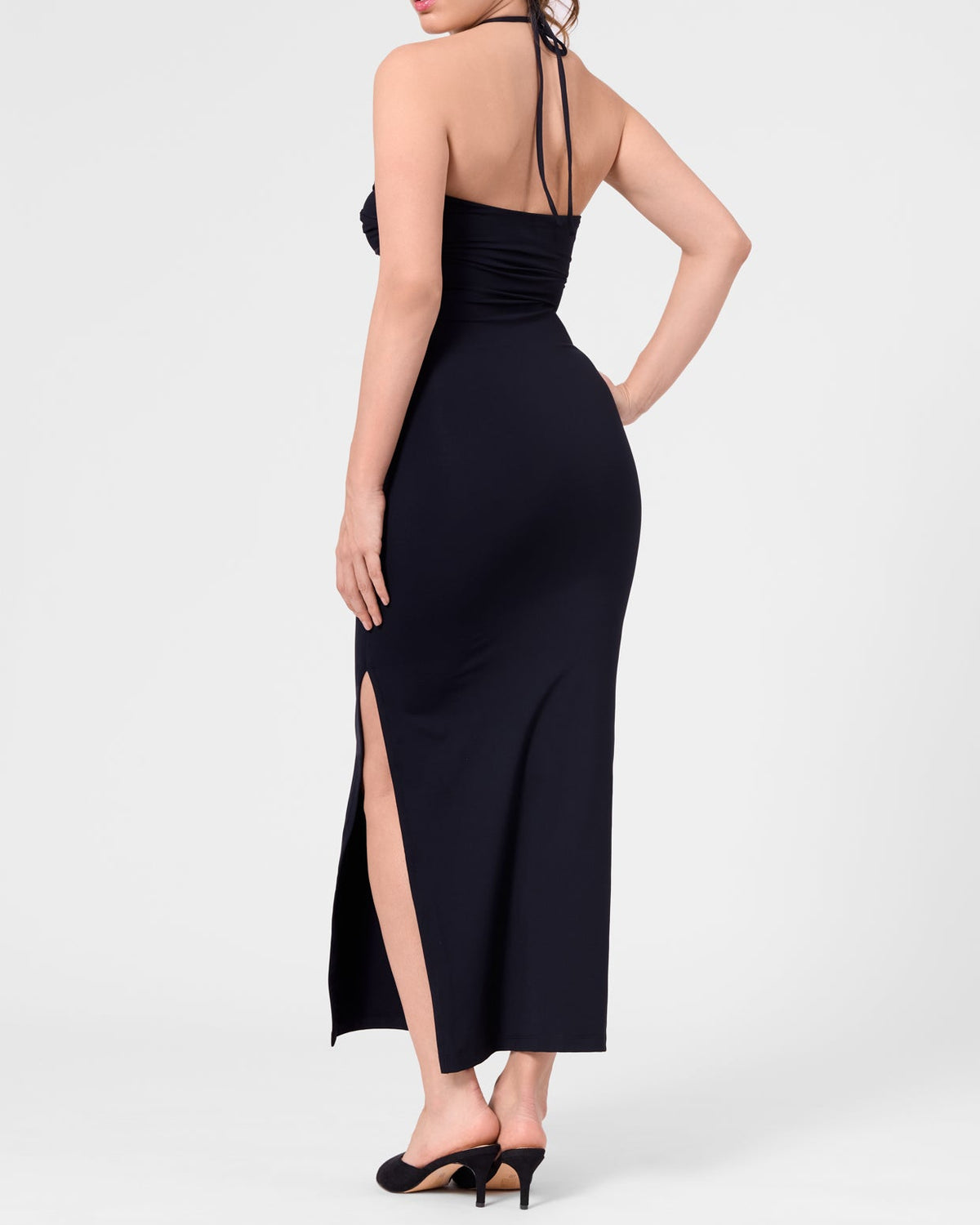Model wearing the ROEM Bartolome Twist Top Dress in Black, back view