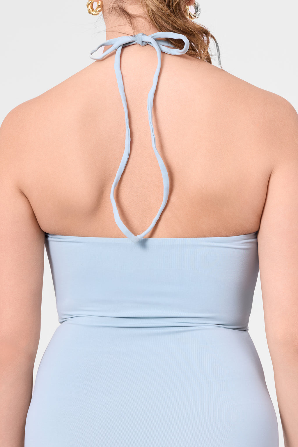 Detail shot of the ROEM Bartolome Twist Top Dress in Pool, halter tie detail