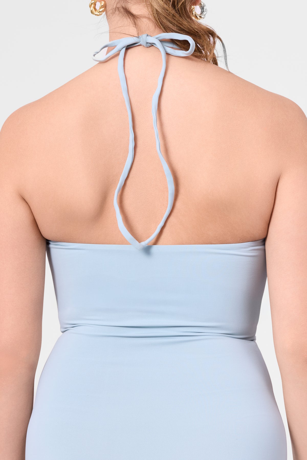 Detail shot of the ROEM Bartolome Twist Top Dress in Pool, halter tie detail