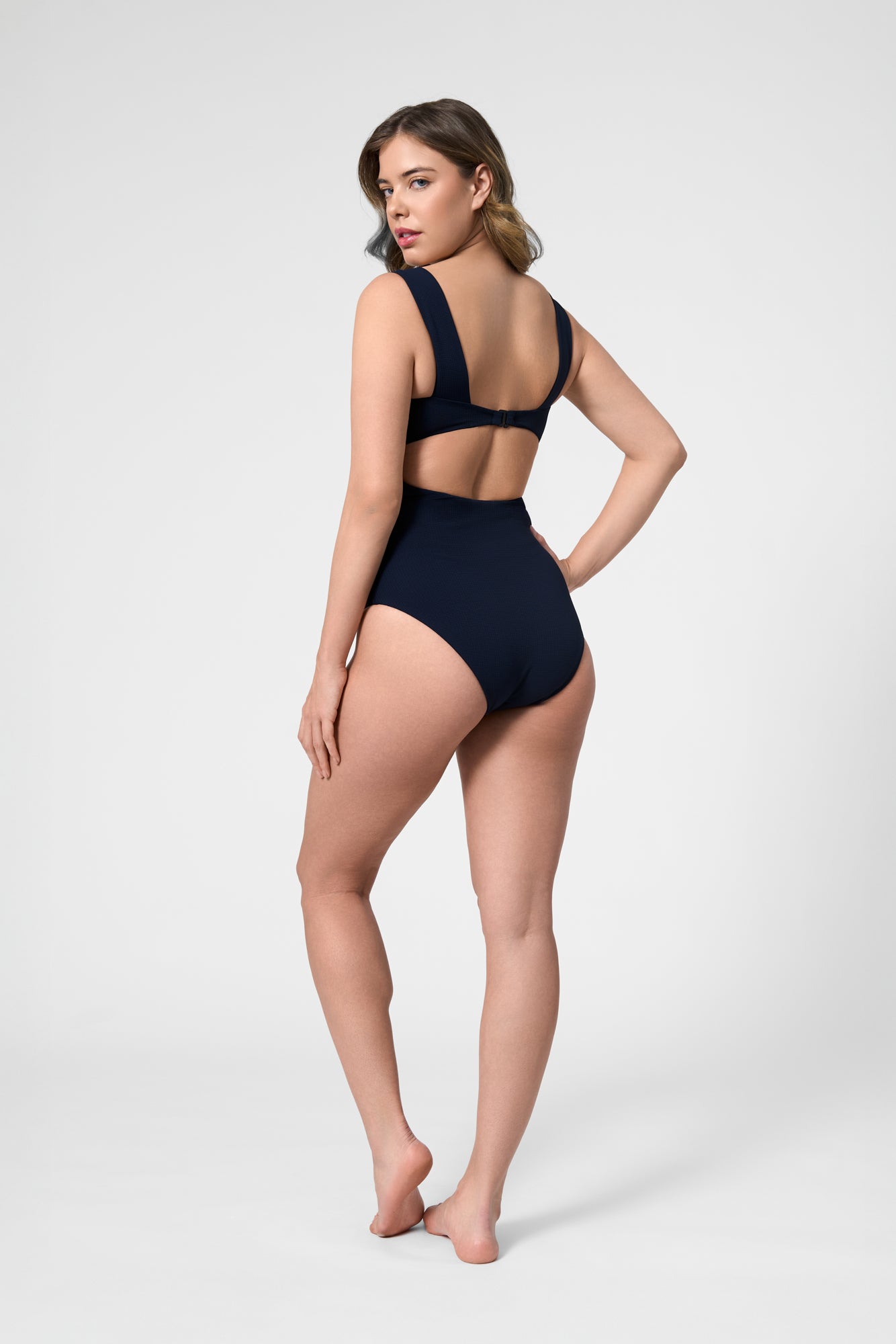 Model wearing the ROEM Calabria One Piece in Indigo, back view