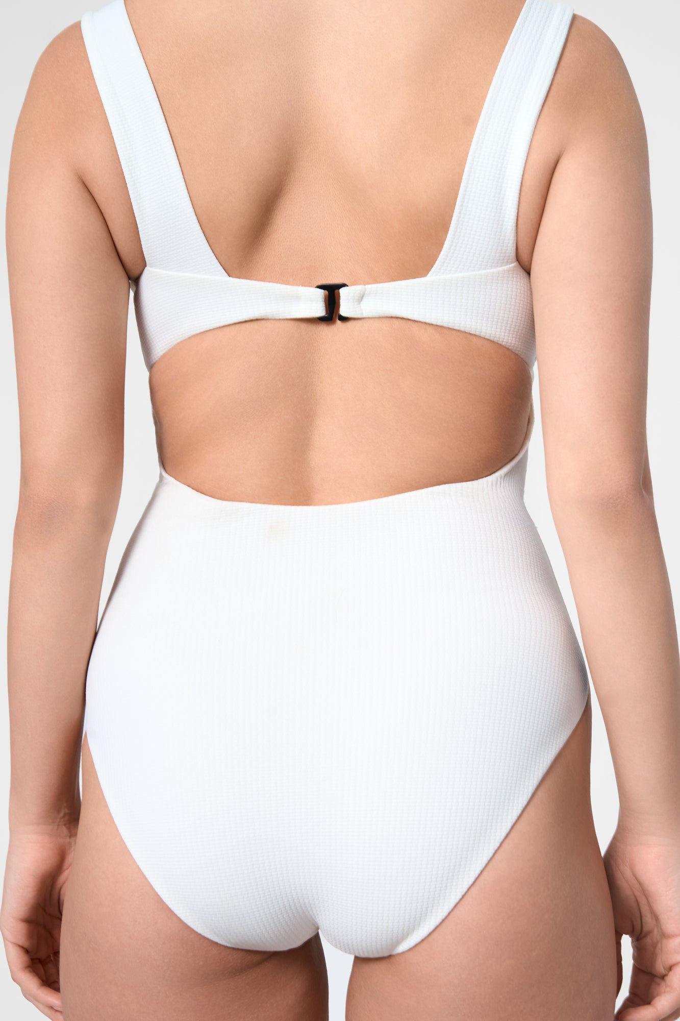 Detail shot of the ROEM Calabria One Piece in Pearl, open-back clasp detail
