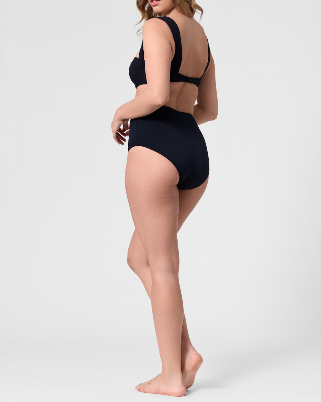 Model wearing the ROEM Calabria Top in Black, back view