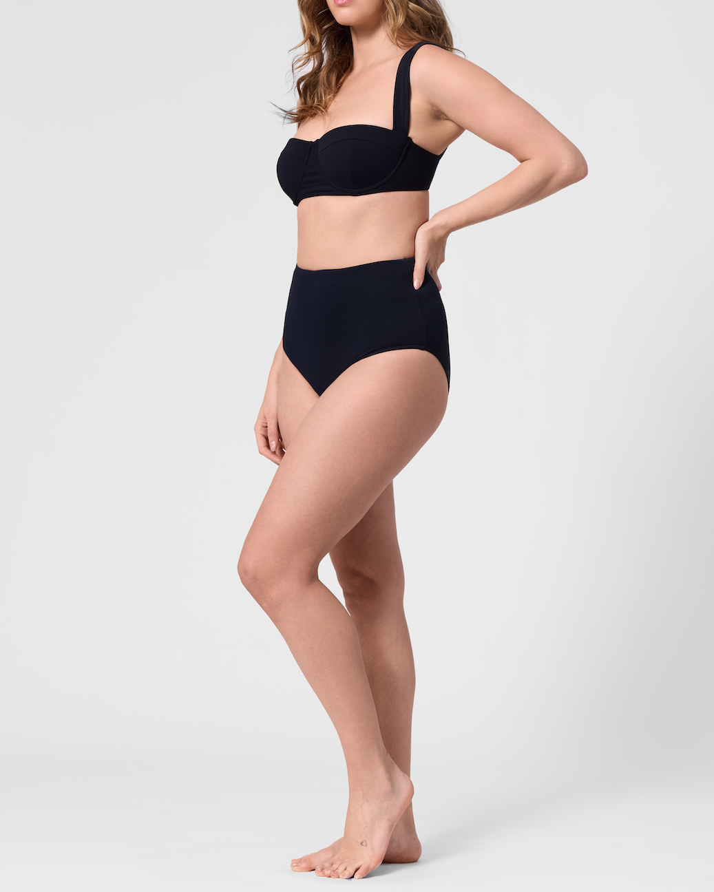 Model wearing the ROEM Calabria Top in Black, side view