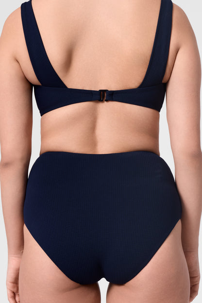 Model wearing the ROEM Calabria Top in Indigo, close-up back view