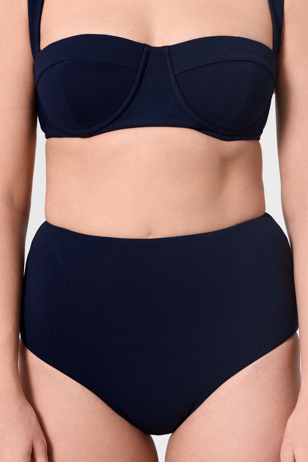 Model wearing the ROEM Calabria Top in Indigo, close-up front view