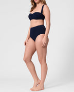 Model wearing the ROEM Calabria Top in Indigo, side view