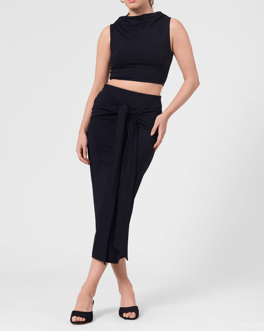 Model wearing the ROEM Grace Swim Top in Black, styled with the Itaso Skirt, front view