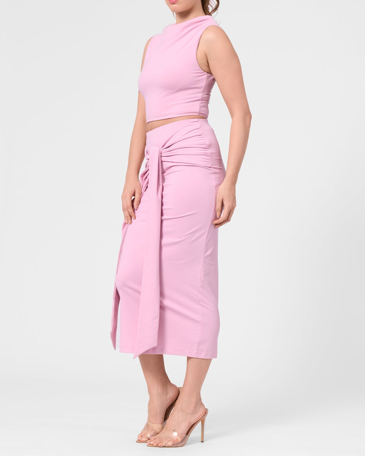 Model wearing the ROEM Itaso Front Wrap Skirt in Bloom, styled with the Grace Top, side view