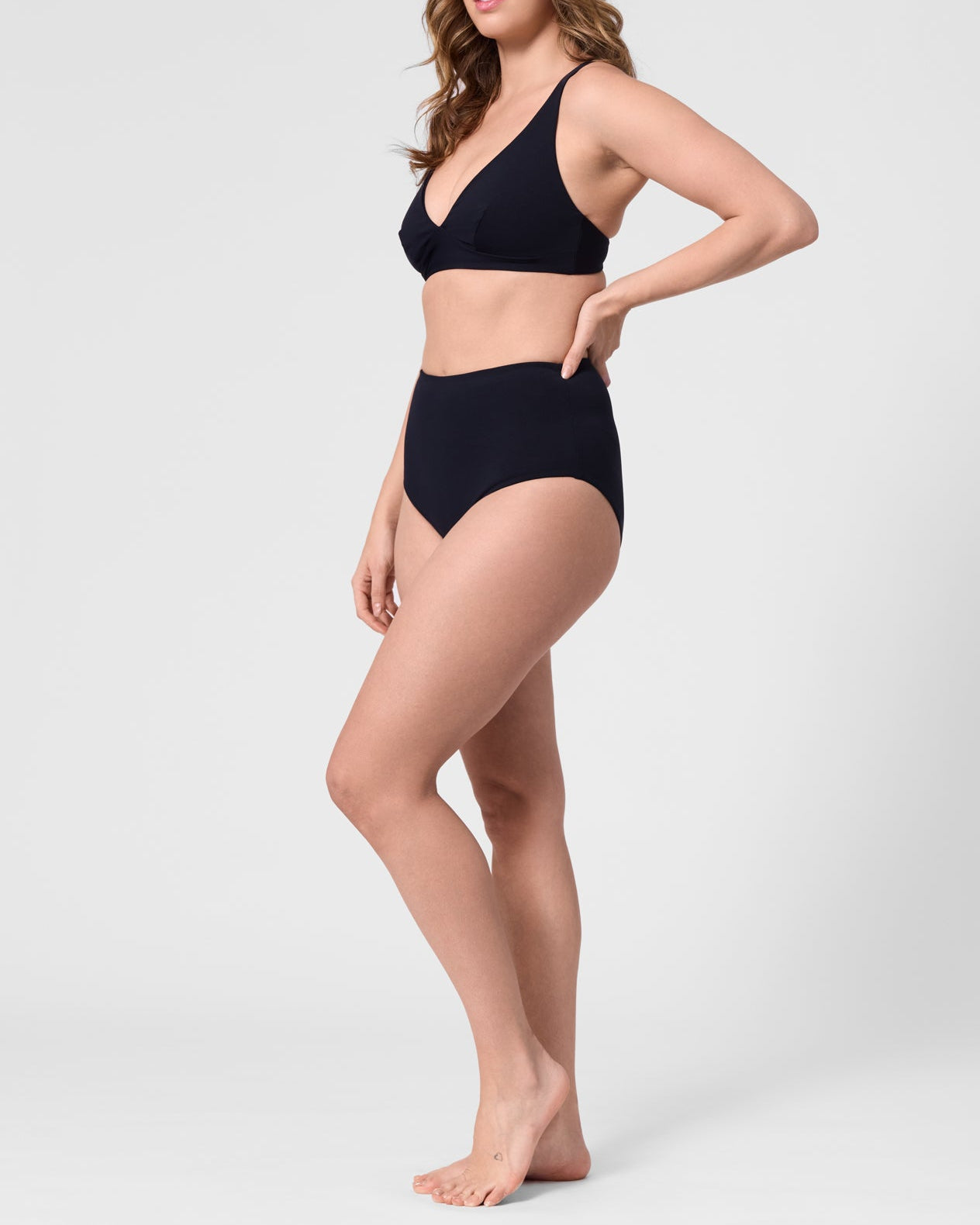 Model wearing the ROEM Lana Bottom in Black, side view