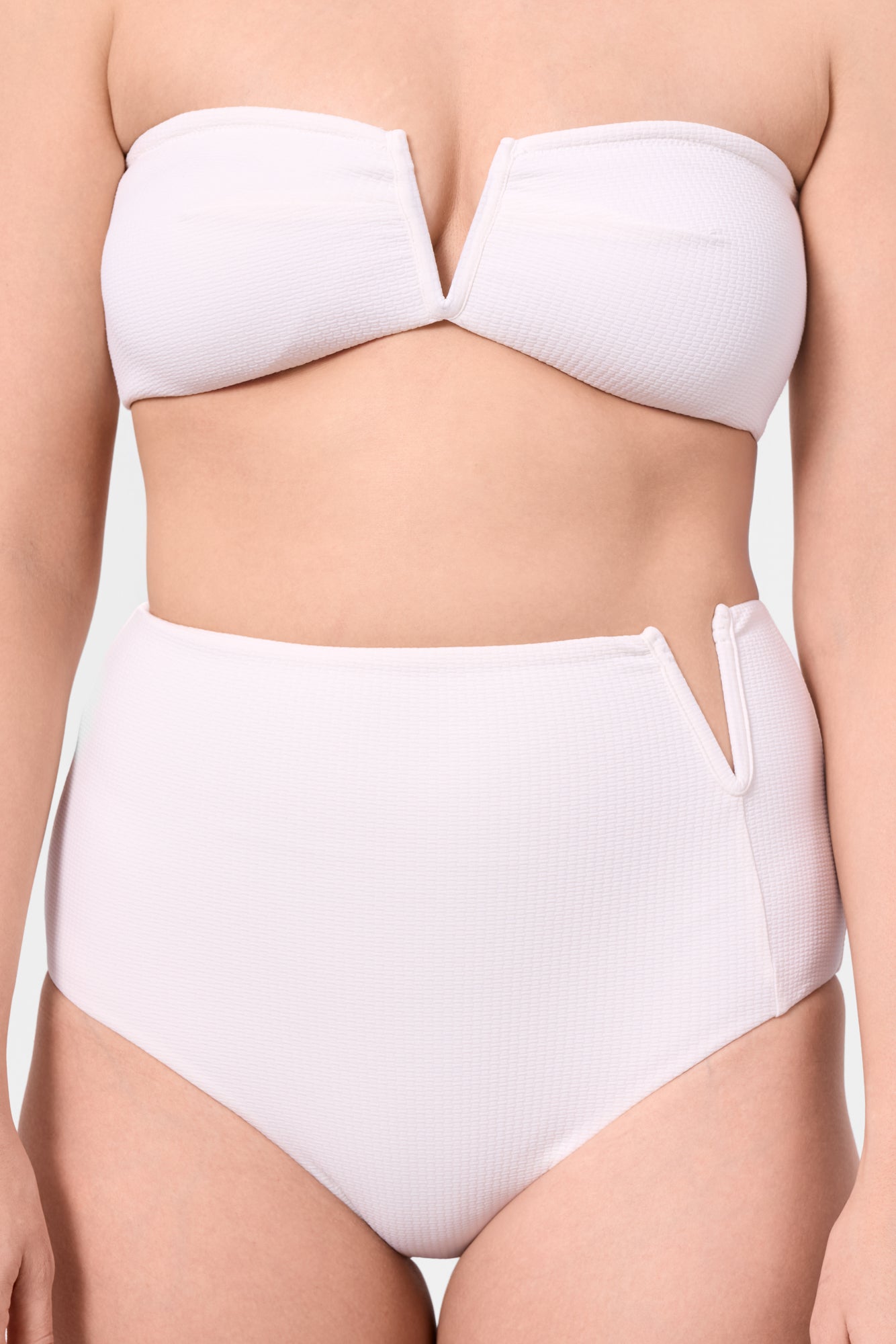 Model wearing the ROEM Marigot V High Rise Bottom in Pearl, front detail view