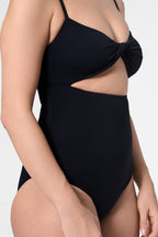 Detail shot of the ROEM Santa Cruz One Piece in Black, twist-front bust detail