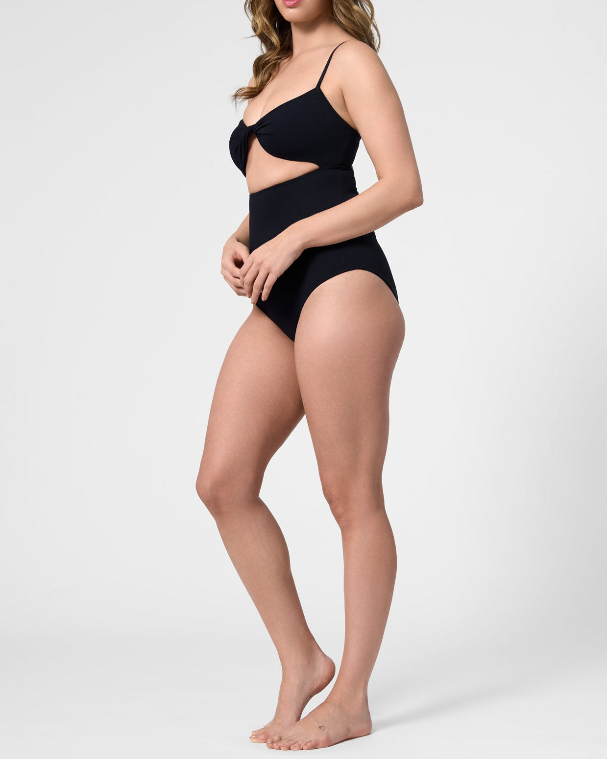 Model wearing the ROEM Santa Cruz One Piece in Black, side view